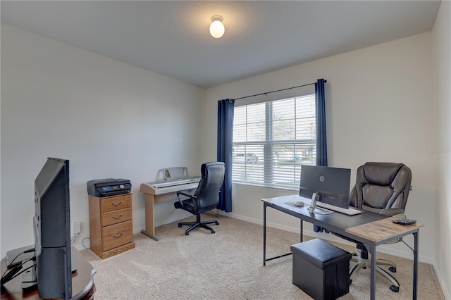 office with baseboards and light colored carpet