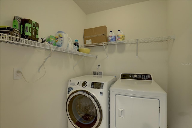 clothes washing area featuring laundry area and washing machine and dryer