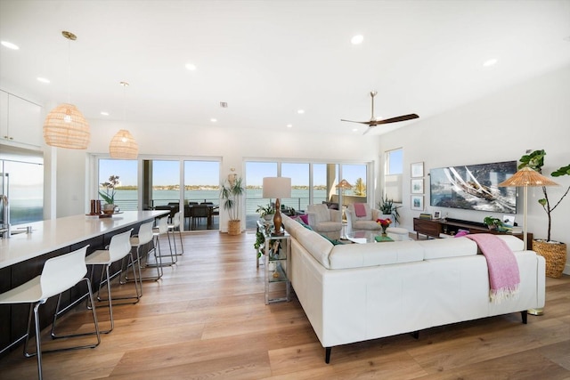 living area with ceiling fan, light wood-style flooring, and recessed lighting