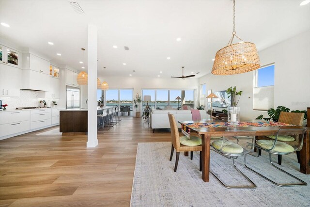 dining room with light wood-style floors, recessed lighting, and visible vents