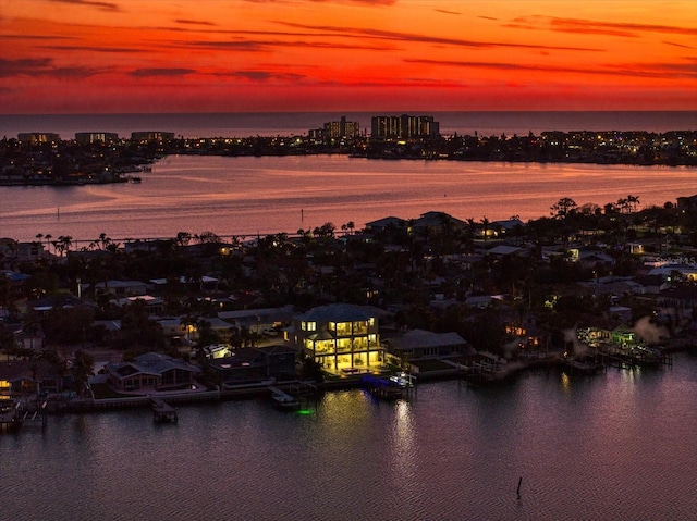 aerial view at dusk with a view of city and a water view