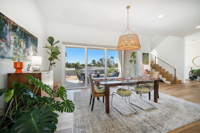 dining area featuring recessed lighting, stairway, and wood finished floors