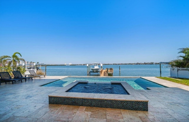 view of pool featuring a dock, a water view, boat lift, and an in ground hot tub