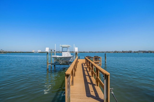 dock area with a water view and boat lift