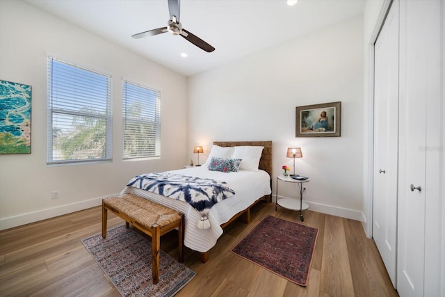 bedroom with recessed lighting, a closet, baseboards, and wood finished floors