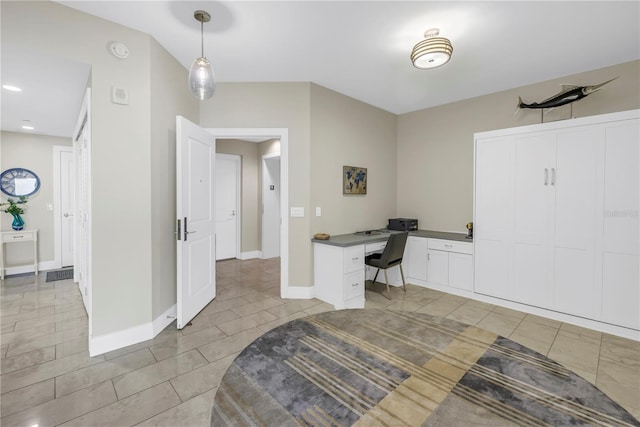 office space with light tile patterned floors and baseboards