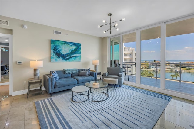 living room with a chandelier, expansive windows, visible vents, and baseboards