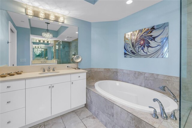 full bathroom featuring a stall shower, tile patterned flooring, vanity, and a bath