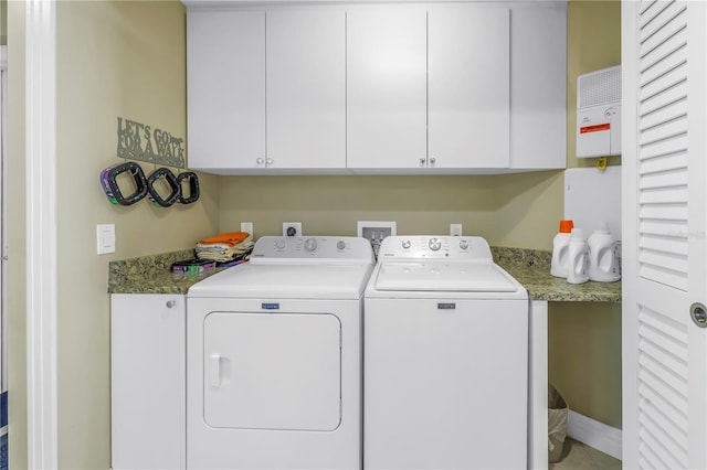 laundry area featuring cabinet space and washer and clothes dryer