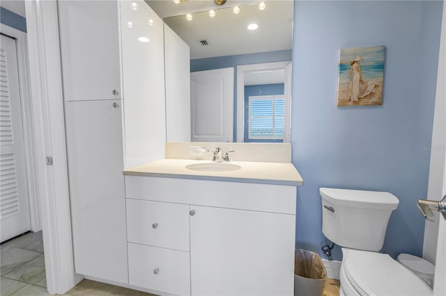 bathroom with visible vents, vanity, and toilet