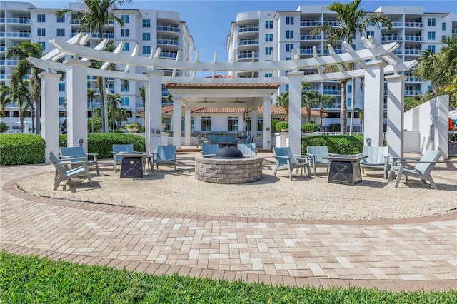 view of patio with an outdoor fire pit and a pergola