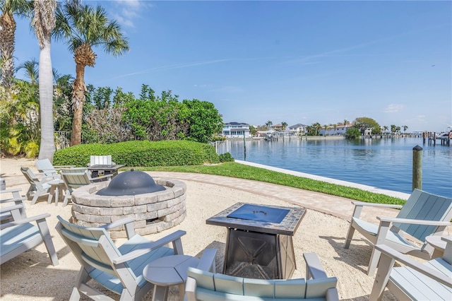 view of patio / terrace with a water view and a fire pit