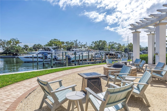 view of patio / terrace with boat lift, a water view, a boat dock, a pergola, and a fire pit