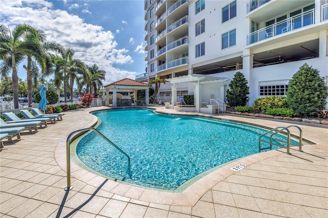 community pool with a patio and a gazebo