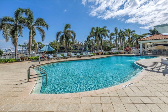 pool featuring a patio, a gazebo, and fence