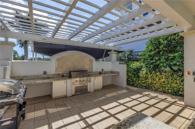 view of patio featuring a grill, area for grilling, and a pergola