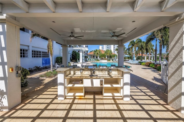 view of patio with ceiling fan, outdoor dining space, and a community pool