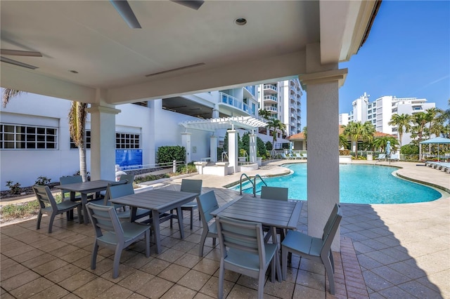 pool featuring a patio area and outdoor dining area