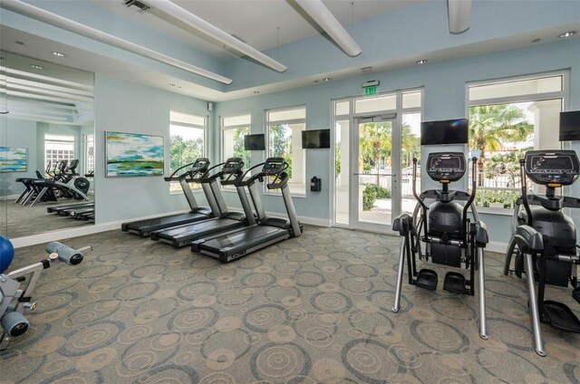 gym with carpet floors, visible vents, and baseboards