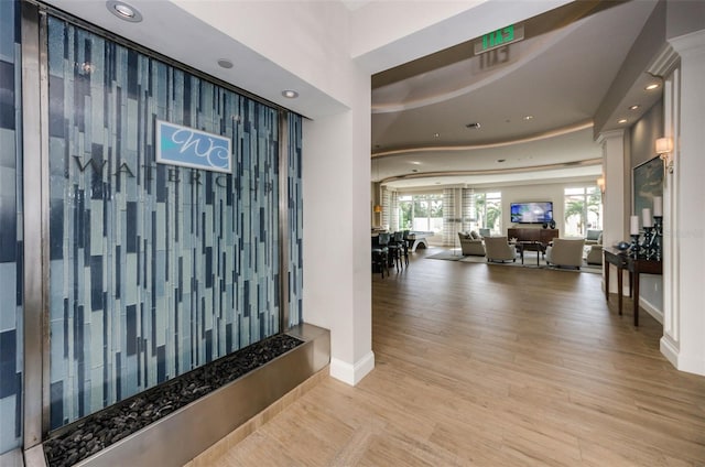 hall featuring recessed lighting, baseboards, and wood finished floors