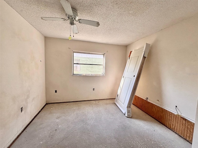 unfurnished bedroom featuring unfinished concrete flooring, a ceiling fan, and a textured ceiling