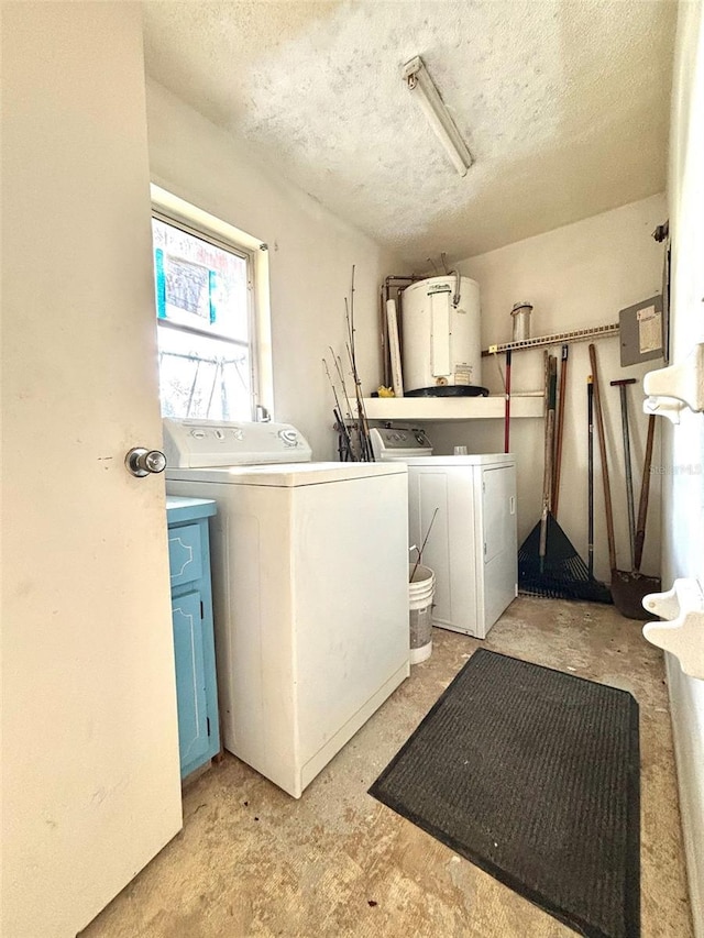 washroom with washer and clothes dryer, a textured ceiling, laundry area, and water heater