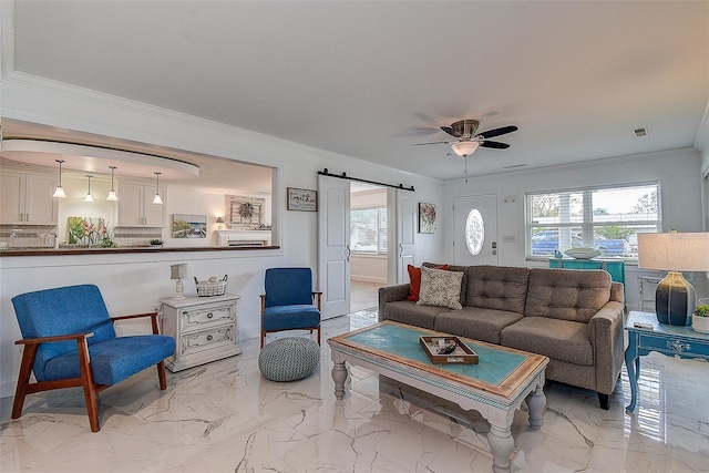 living area featuring a barn door, a ceiling fan, visible vents, marble finish floor, and crown molding