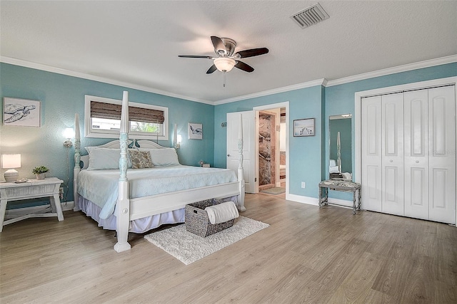 bedroom featuring light wood-type flooring, visible vents, and crown molding