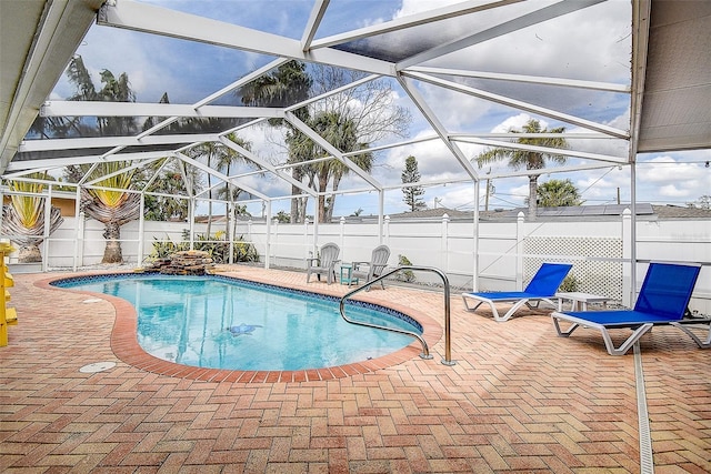 view of swimming pool with a lanai, a patio area, a fenced backyard, and a fenced in pool