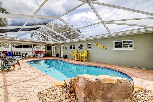 outdoor pool featuring a lanai and a patio area