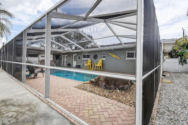 view of pool featuring a lanai, fence, a fenced in pool, and a patio