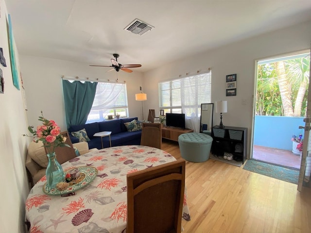 dining area featuring visible vents, wood finished floors, and a ceiling fan