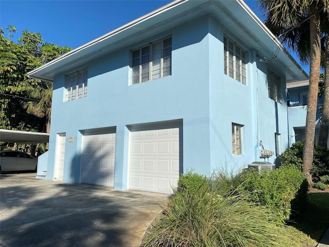 view of property exterior featuring stucco siding and a garage