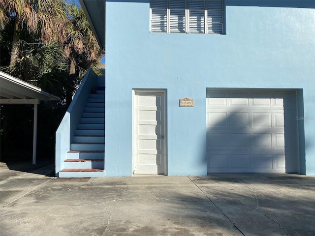 garage with concrete driveway