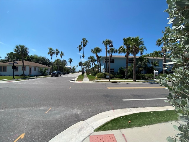 view of street featuring curbs, street lighting, and sidewalks