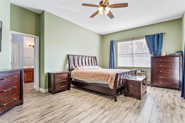 bedroom with lofted ceiling, ensuite bathroom, ceiling fan, light wood-type flooring, and baseboards