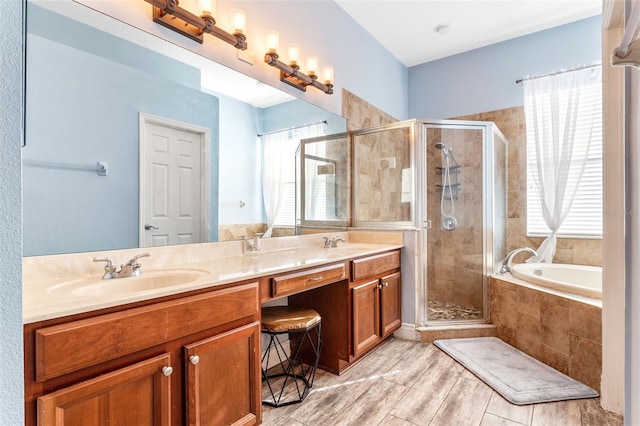 full bath featuring double vanity, a stall shower, a sink, and a bath