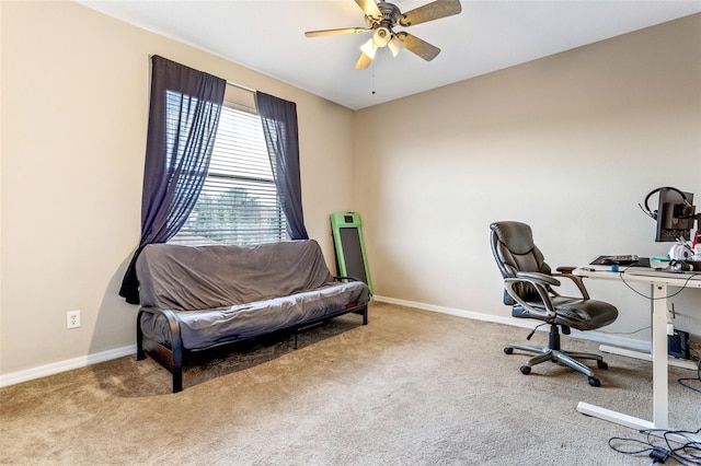 home office featuring carpet floors, a ceiling fan, and baseboards