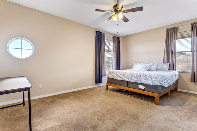 bedroom featuring ceiling fan, multiple windows, carpet flooring, and baseboards