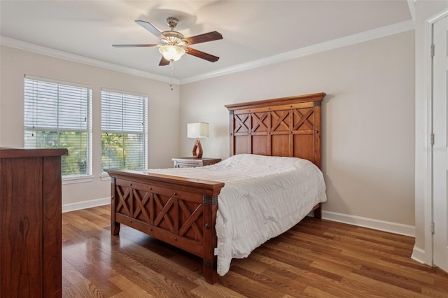 bedroom with ceiling fan, wood finished floors, baseboards, and ornamental molding