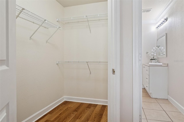 spacious closet with light tile patterned flooring and visible vents