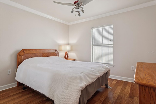 bedroom with baseboards, a ceiling fan, wood finished floors, and crown molding