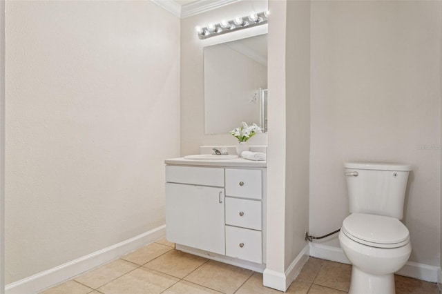 bathroom featuring tile patterned floors, toilet, vanity, and baseboards