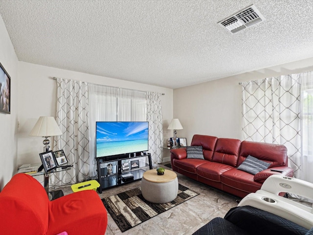 living room featuring a textured ceiling and visible vents