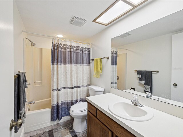 full bath featuring a skylight, visible vents, toilet, shower / bath combo with shower curtain, and vanity