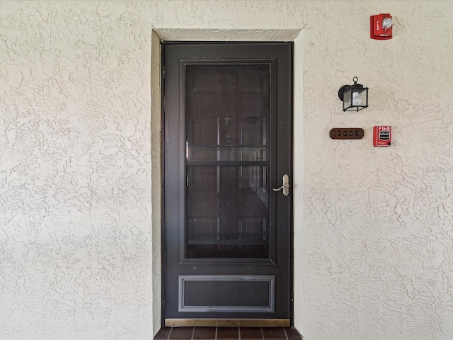 view of exterior entry with stucco siding