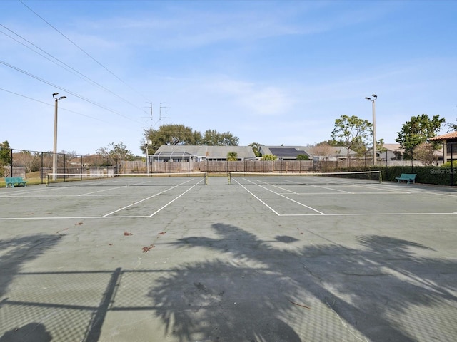 view of tennis court featuring fence