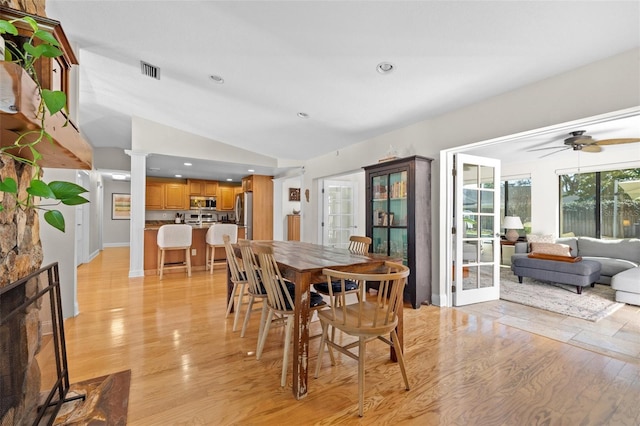 dining space featuring light wood finished floors, visible vents, lofted ceiling, ceiling fan, and recessed lighting