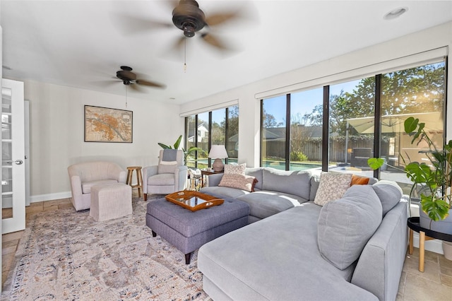 living area with stone finish flooring and baseboards