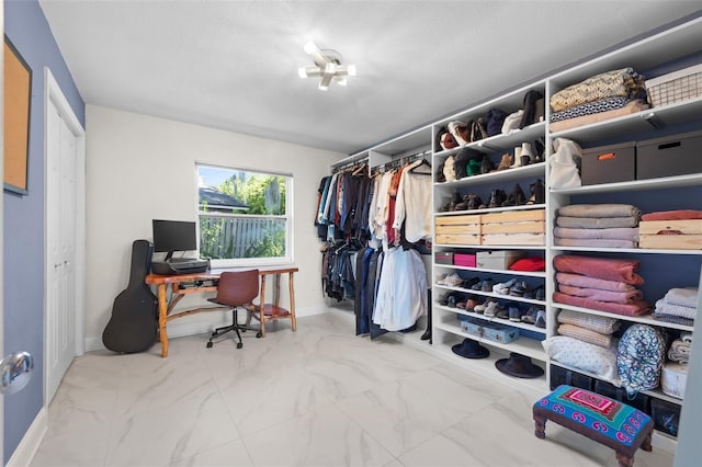 spacious closet with marble finish floor